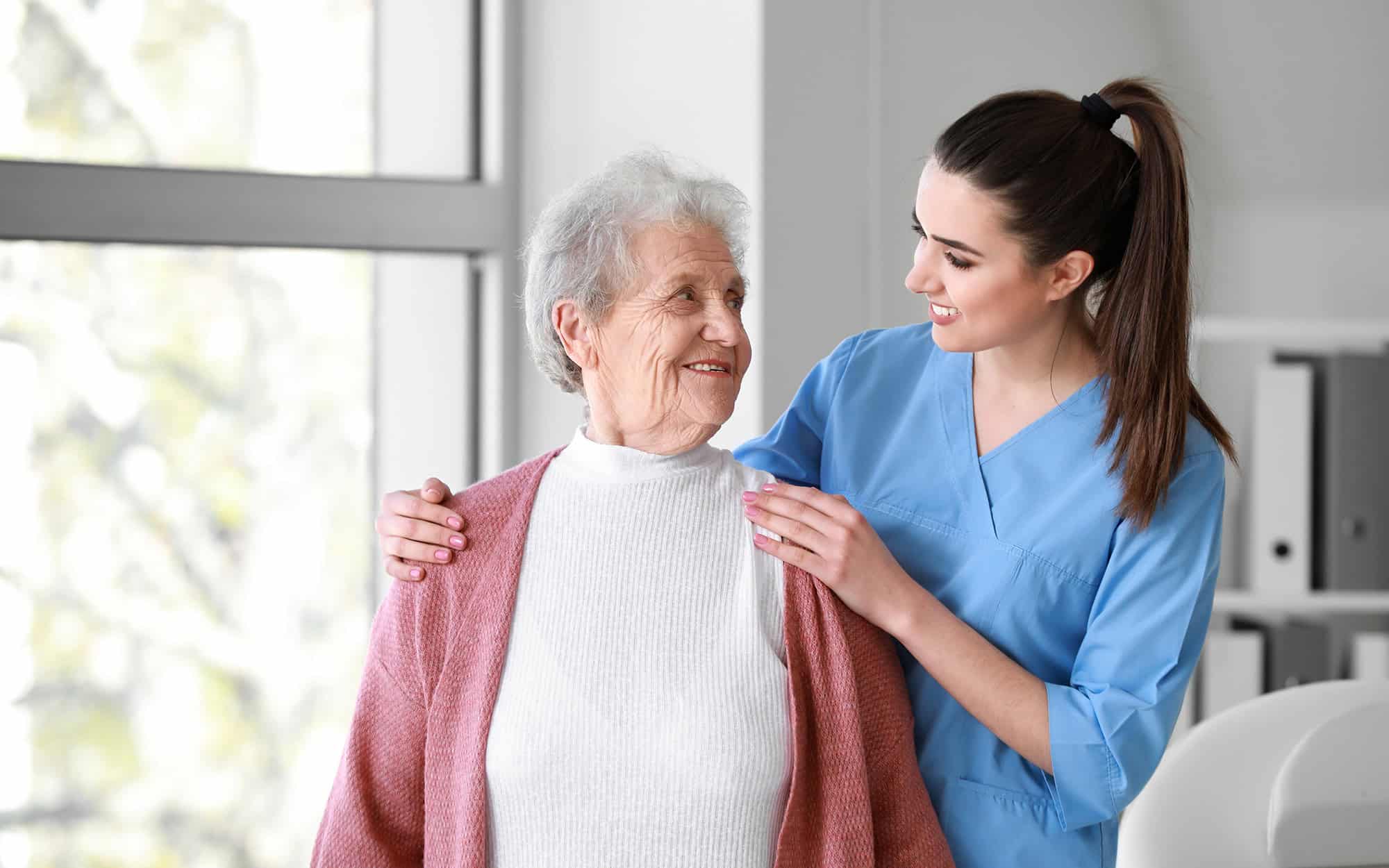 Medical worker with senior woman in nursing home