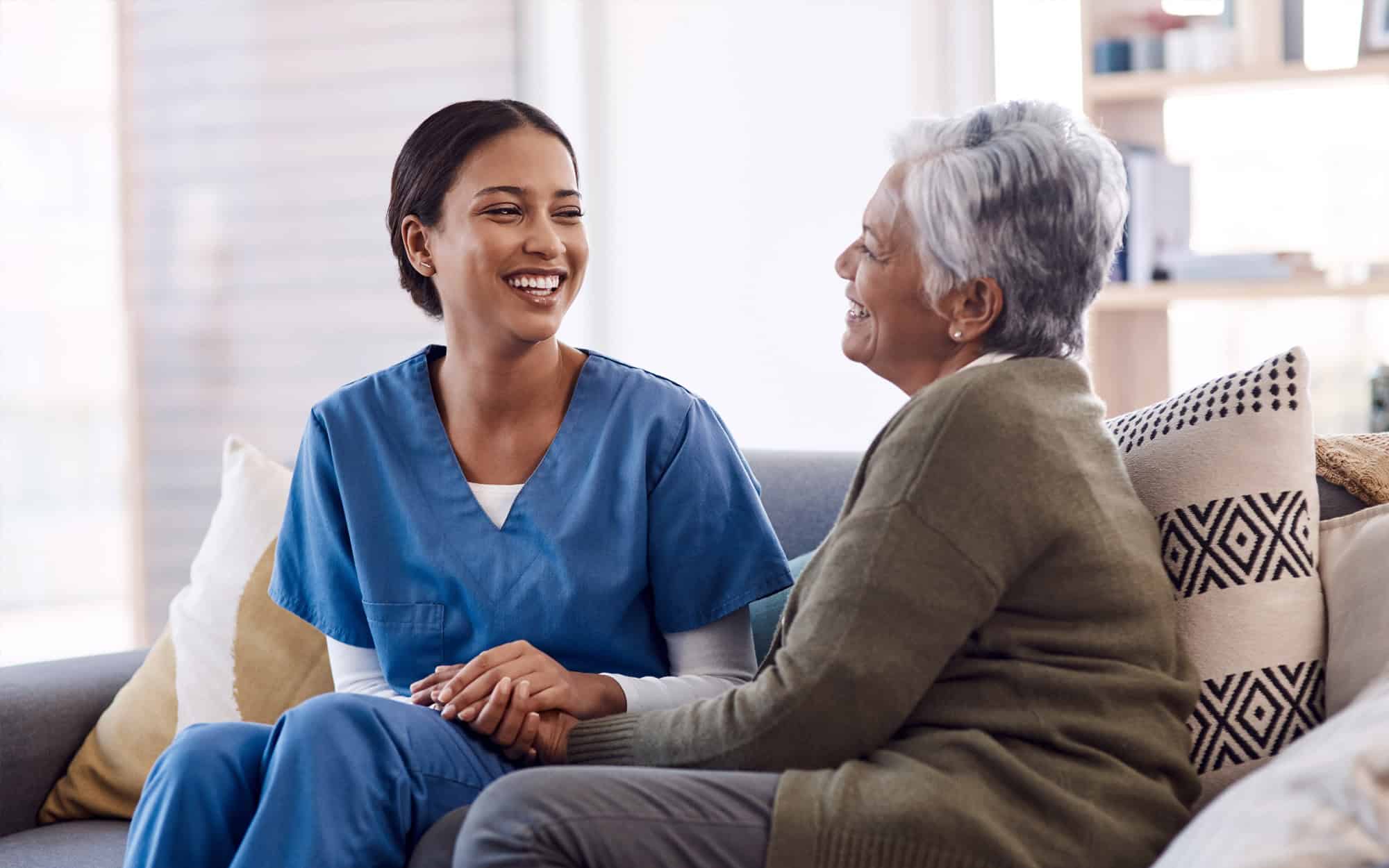 caregiver with senior woman for conversation